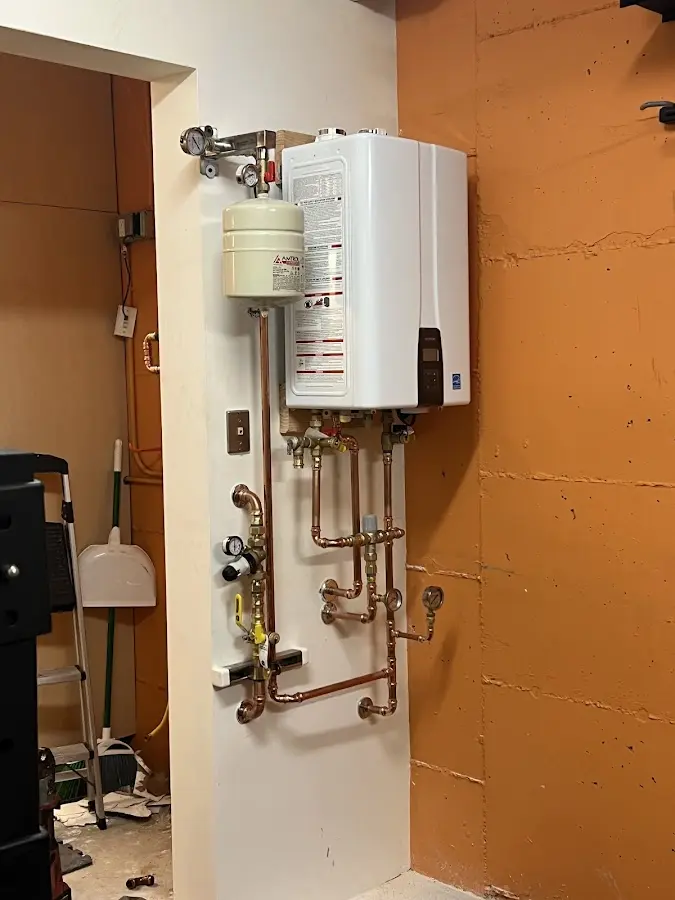 Plumbing technician inspecting water heater connections in Klamath Falls